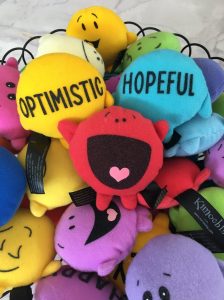 Family Counselling: colourful emotion toys with the words optimistic and hopeful.